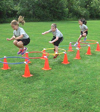 Participants Hopping Over Active Obstacle Challenge Course